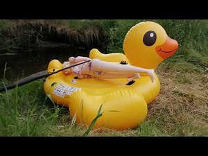 Inflatable Kimmi doll in a colourful bikini, inflated with a hand pump, lying on a duck - 13.06.2023
