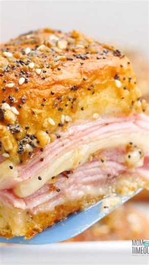 RECIPE 👉: https://www.momontimeout.com/ham-and-cheese-sliders-recipe/ A game day staple! These easy Ham and Cheese Sliders are made with layers of ham and cheese nestled inside soft, sweet Hawaiian rolls and then topped with a seasoned butter mixture that is divine! Baked until hot, these sliders are a handheld appetizer that kids and adults alike will love! | Mom On Timeout