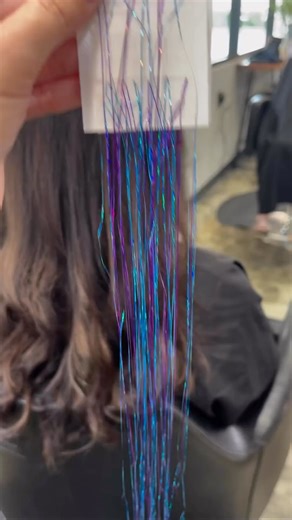 2.1K views | Prepping for the New Year with a touch of sparkle! ✨✨ One of our favorite ways to use the single sided tape is creating custom tinsel extensions!  Are you adding tinsel into your hair for the New Year? : @claudiadidmyhair . . . #newyearhair #nyehairinspo #holidayhairinspo #newyearseve #tinsel #hairtinsel | Babe Hair Extensions | Facebook