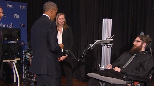 Watch Obama fist bump a robotic arm powered by a brain chip