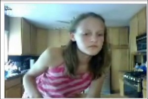 Young amateur webcam model using a toothbrush and playing with an animal
