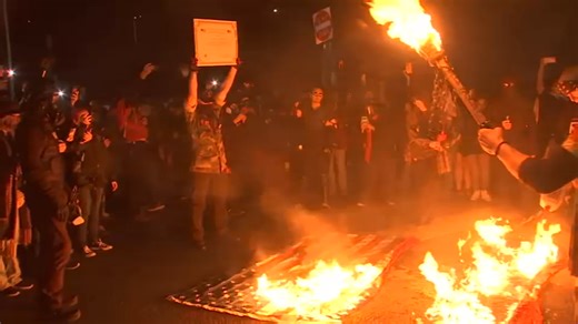 Protesters break through gates at Portland ICE facility, burn flags on Saturday night