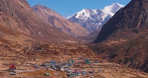 Aerial Drone Shot of Sherpa Village in Langtang, Nepal Amid Snow-Capped Mountains