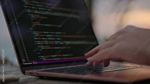 Young female developer working on laptop by the ocean. Woman freelancer coding at outdoor tropical cafe at sunset. Caucasian girl working remotely typing on computer at exotic location close-up Stock Video