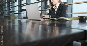 Concerned woman working on laptop computer and looking away thinking solving problem at office. Serious attractive female working with notebook Stock Video