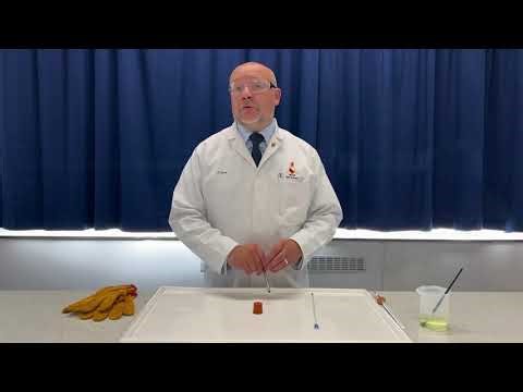 Inserting a thermometer (or glass tubing) through a rubber bung