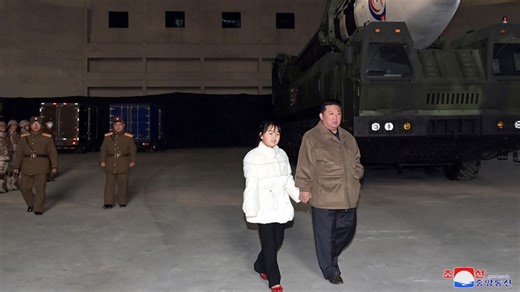 Kim Jong-Un seen with daughter at missile launch site
