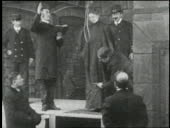 Executioners hang a woman.