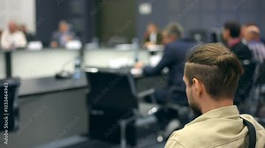 Press conference at round table. Speaker man CEO press conference forum seminar. Group of multiracial colleagues listening. Closeup of hands. Businessman speaking microphone discussion board meeting.
