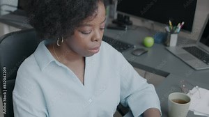 Tilt up portrait of young African American female programmer smiling at camera sitting on chair by desk in office with programming codes on computer and laptop monitors Stock Video