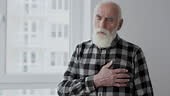 Old unhealthy man touching chest feeling sudden heartache, risk of...