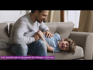 Affectionate young father tickling little laughing child son stock video footage