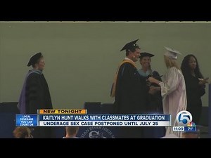 Kaitlyn Hunt walks with classmates at graduation
