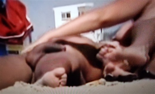 Semi hard hung black hunk on the beach