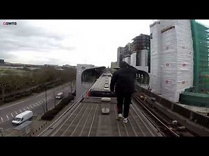 Astonishing moment free runners ride on top of a train for a stunt