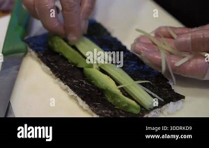 Gloved Hands Rolling Avocado Cucumber Maki On Nori And Bamboo Mat, Rice Compression And Precision Slicing, Vegan Sushi Preparation Stock Video Footage - Alamy