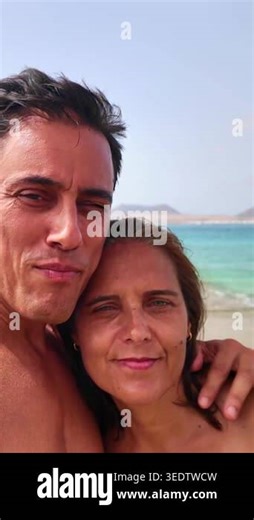 Romantic mature couple enjoying a sunny day at the beach while taking a selfie on vacation Stock Video Footage - Alamy