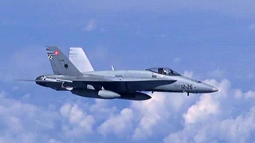 NATO F/A-18 warplane veers away when Russian Su-27 jet approaches