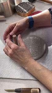 Part 3: Reviving the peacock stamp. Finishing touches on the wet work in 3x speed, using small stamps and hole cutter. It will be a while before drying and bisque firing takes place. Then I can decorate and glaze. I made a series of 3 on the same day. 🤞#arttiles #artworkinprogress #peacockart #woodenstamps #artreels #claydemo #clayart #clayartist #handcrafted #wip #artworkinprogress #annarborartist #womenartistsmichigan #ceramicart @annarborpottersguild | Cher Rusling Tiles