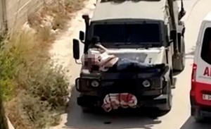 Israeli forces strap Palestinian to jeep bonnet and drive off during raid