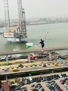 Behold A Man walking on a rope across the bridge and the train tracks at CMS Bus Stop in Lagos State. His name is Jaan Rose, an Estonian stuntman who's also a 3-time world champion and the holder of numerous world records in tightrope walking. | News In Naija | Facebook