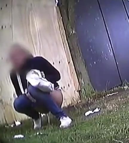 Girl peeing in grass at festival