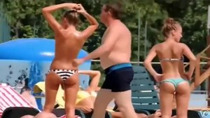 Topless skinny girl looks sexy at the water park