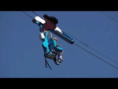 Roger Williams Park Zoo has a new attraction: Soaring Eagle Zip Ride. Two riders secured onto side b