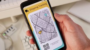 clip-1048441921-tracking-parcel-using-mobile-phone-app-showing