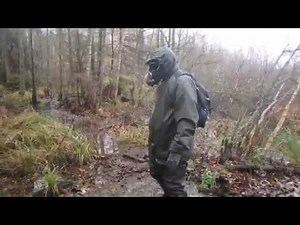 Walk in rainwear, waders, gloves and gasmask in the swamp