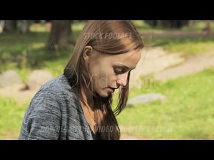 Sick woman blowing his nose into tissue, outdoors