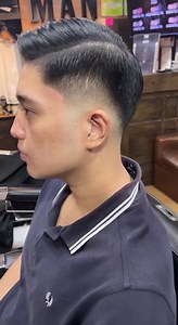 Experience timeless elegance in motion: Mastering the classic side part comb over with a sleek fade, striking the perfect balance between sophistication and manageability. #ManBarbers #manbarberstaft | Man Barbers Philippines