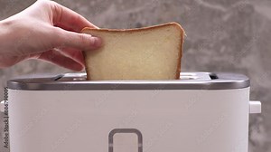 Woman puts bread in toaster for toasting. Close up, 4k slow motion footage.