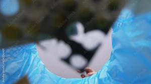 recycling, waste sorting and sustainability concept - hand throwing expired medicine pills into trash can