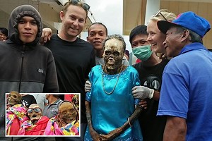 Tourists pose at 'zombie' festival where Indonesians dig up relatives