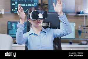 Female scientist using virtual reality goggles in a neurology clinic Stock Video Footage - Alamy