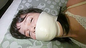 Microfoam gagged girl struggles in bondage