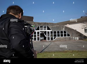 A Hakuhodo Inc. videographer collected footage for a Japan Maritime Self-Defense Force promotion video at Marine Corps Air Station Iwakuni, Japan, on November 29, 2016. The JMSDF public affairs team escorted the crew around the base to document operations and aviation facilities. Filming focused on the Zero Hangar, a unique feature at MCAS Iwakuni, capturing aircraft displays, maintenance areas, and base infrastructure. The production emphasized JMSDF community presence and professional media pr