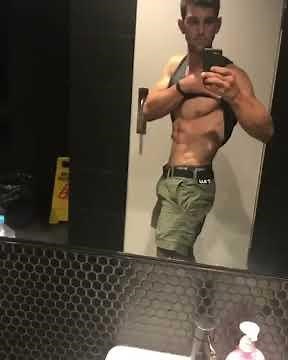 Matt flexing his biceps and abs