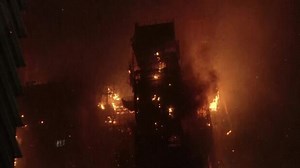 Flames engulfed a construction site in Hong Kong’s popular shopping district early on Friday.Hong Kong firefighters battled the blaze, which erupted at the site in the densely built Tsim Sha Tsui.