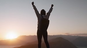 clip-1052859839-young-inspired-dreadlocks-woman-raises-her-hands