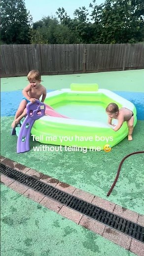 Toddlers are pushing each other down the slide and into the paddling pool!