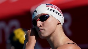 Why do some Olympic swimmers wear two caps?