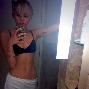 Miley Cyrus Wears Bra and Booty Shorts, Tweets Bedroom Selfie and Works in a Marijuana Leaf Print—See the Pics