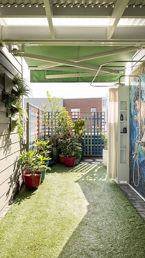Join us for a tour of our award-winning rooftop! This extraordinary space features an outdoor shower and a greenhouse. This area is designed for soaking up the sun, enjoying lush greenery, and embracing the warmth of spring. | Kathy Corbet Interiors