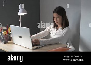 Schoolgirl at home schooling. The girl sits at the table with textbooks doing homework Stock Video Footage - Alamy