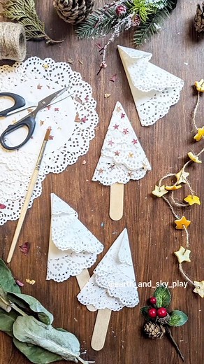 Doily Christmas Trees decorated with Nature Stars! ⭐ A simple Christmas activity for the little ones. Oh it's time to open a fresh pack of doilies and get the Christmas crafts going! (Yay!!!!) Shout out to @stallotown for making beautiful gem stone versions of these! Fold your doily as shown, glue to a lolly stick and use a punch to create lots of stars from your dried leaf collection! This punch is from @lidlgb a couple of years ago but I spotted them in the middle aisle again recently (they ha