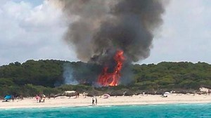 Wildfire panic in Majorca as 100 tourists are evacuated due to massive blaze encroaching on famous Es Trenc virgin beach