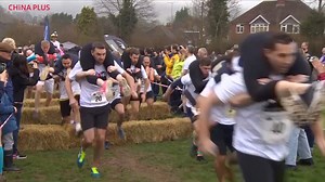 20K views · 549 reactions | The 11th annual UK Wife-Carrying Championships took place Sunday in the town of Dorking, Surrey, England. Couples raced over a hilly 380-meter course, which features a hurdle obstacle, plus a splash zone, ensuring competitors get soaked before the final straw bales leading to the finish. | China Plus Culture | Facebook
