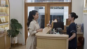 Female Client Getting Tray with Towels before Procedures at Spa Salon